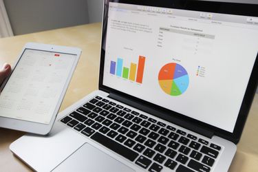 Laptop and notebook on a desk representing the beginning of a blogging journey