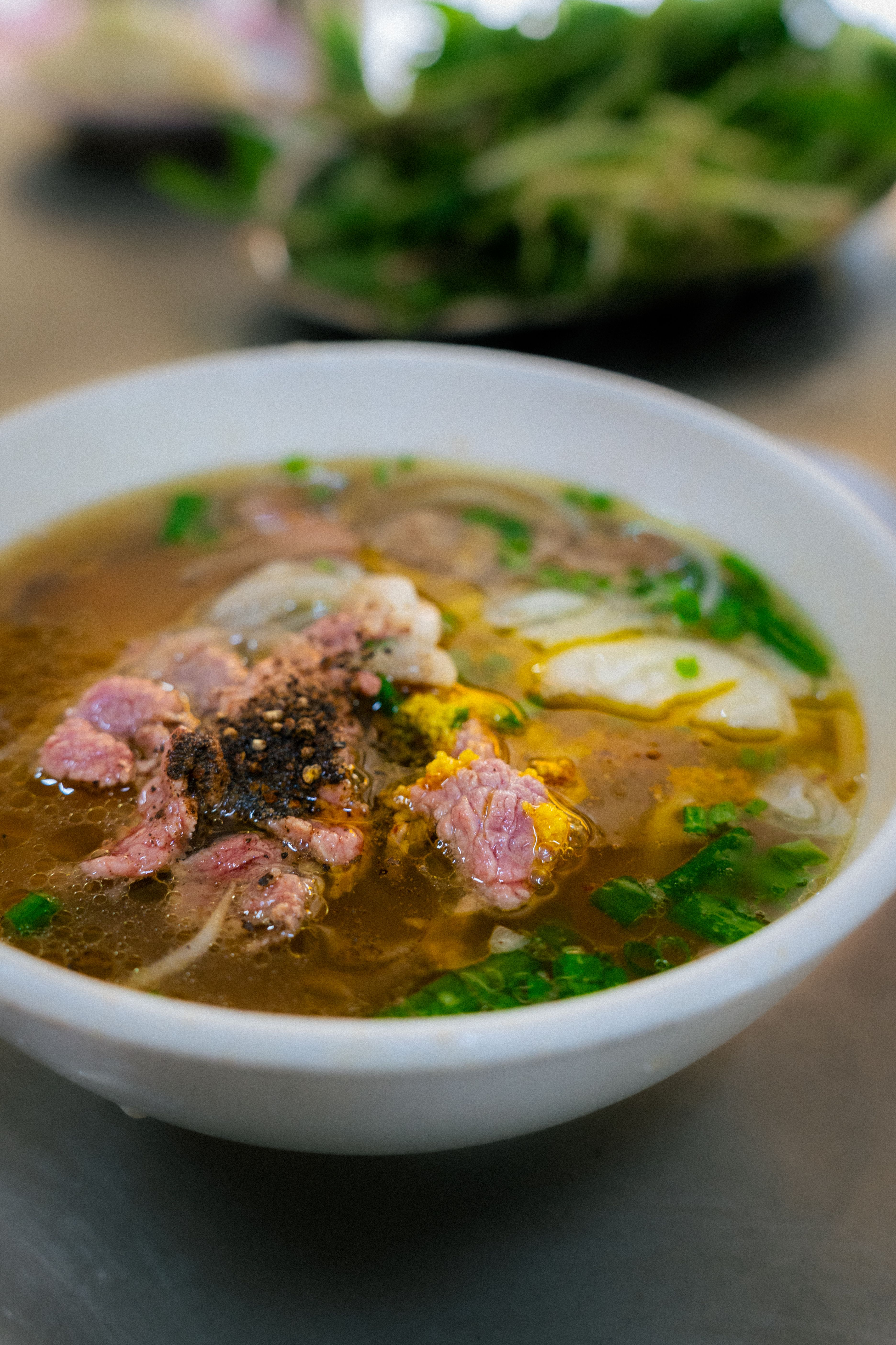 Savor the taste of Vietnamese pho with fresh herbs and beef in Ho Chi Minh City.
