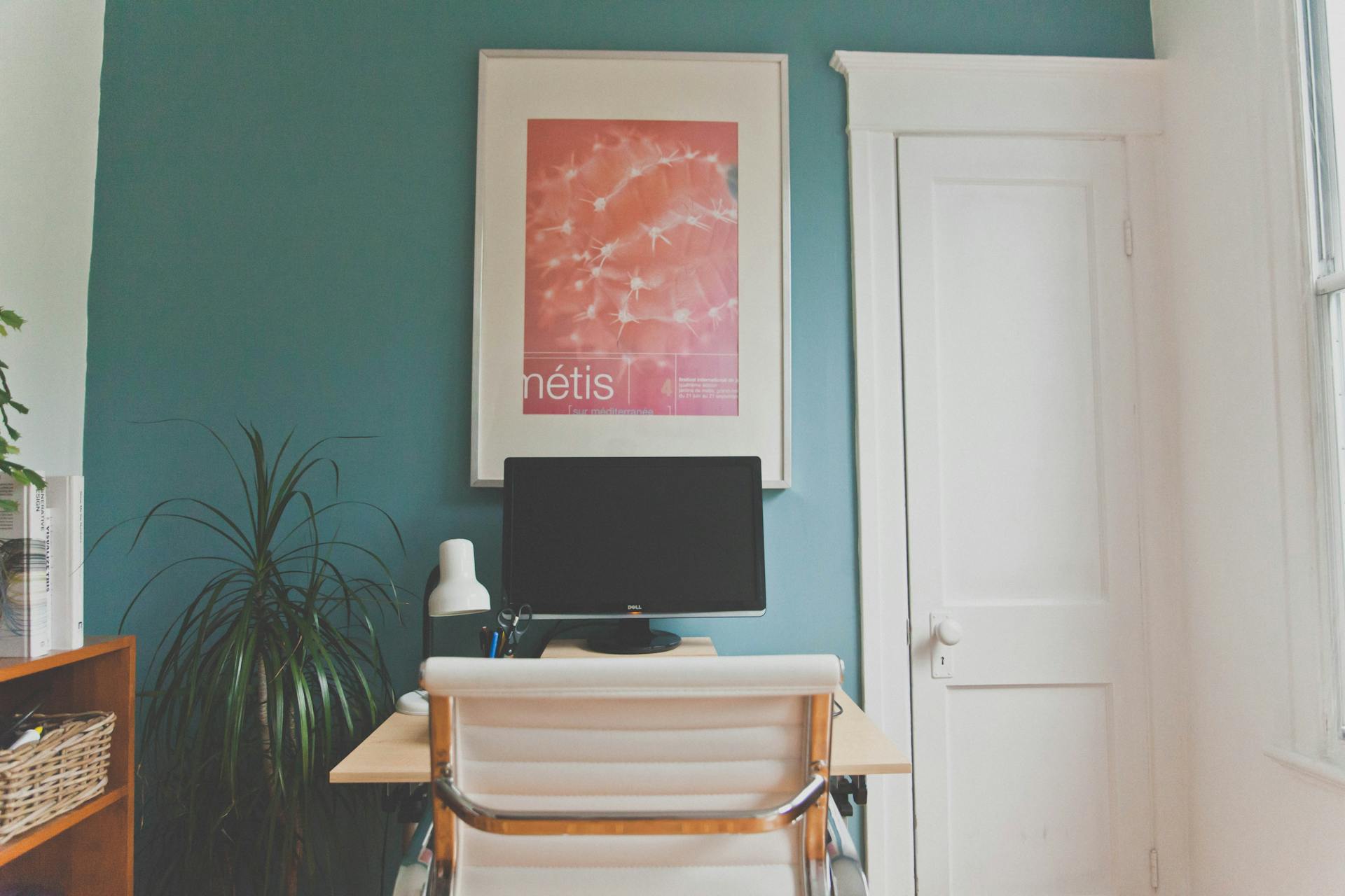 Contemporary home office setup with desk, chair, and decor elements in a minimalist design.