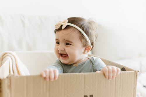 Free A baby is smiling in a cardboard box Stock Photo