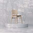 Elegant wooden chair on a round platform with marble background, showcasing Scandinavian design.