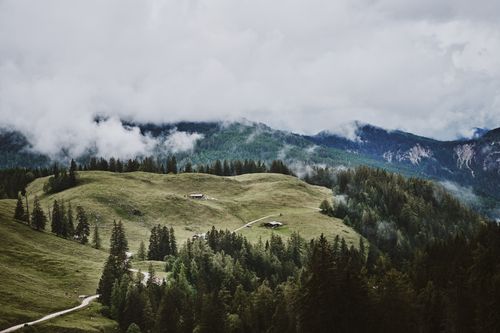 Free Breathtaking view of rolling hills and forests in Berchtesgaden, Germany, with misty mountains in the background. Stock Photo