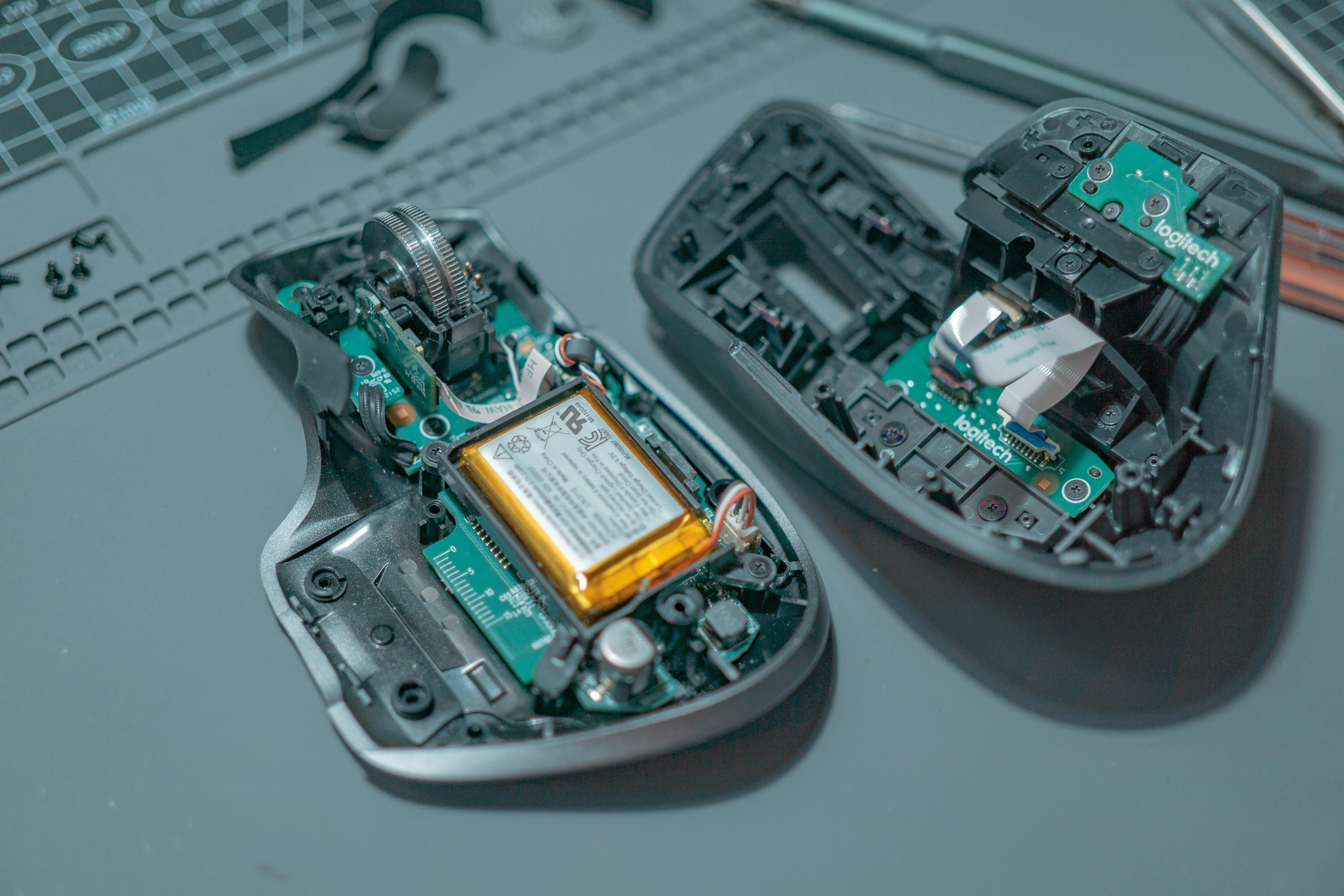 Close-up of a disassembled computer mouse revealing internal circuit boards and components.