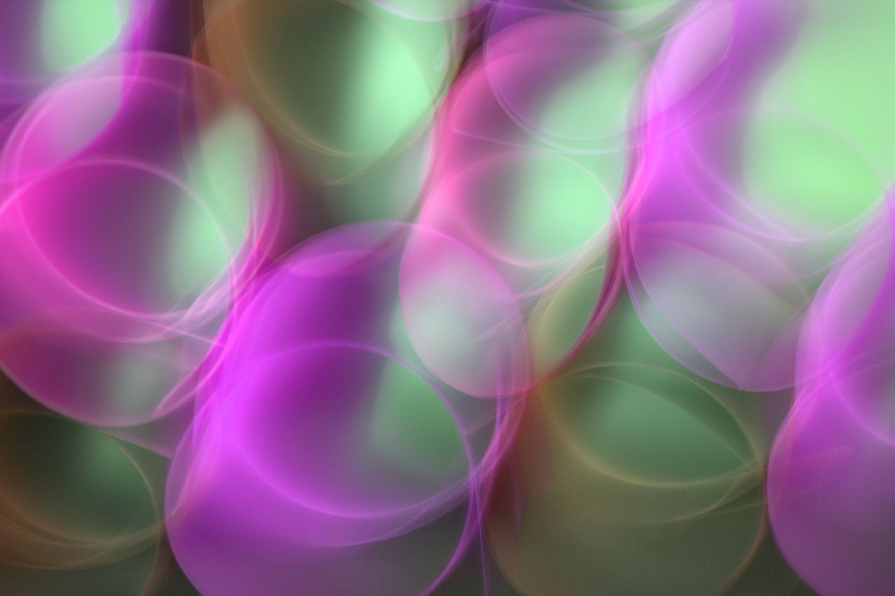 colorful abstract bokeh of pink and green lights creating a dreamy eff