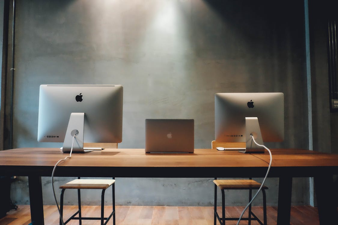 Free Two Silver Imac on Table Stock Photo