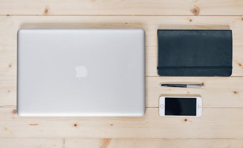 Silver Macbook Beside Wallet