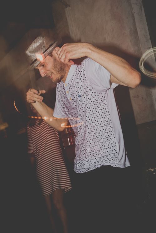 Free A lively dance scene with a man in motion wearing a hat at a vibrant club party. Stock Photo
