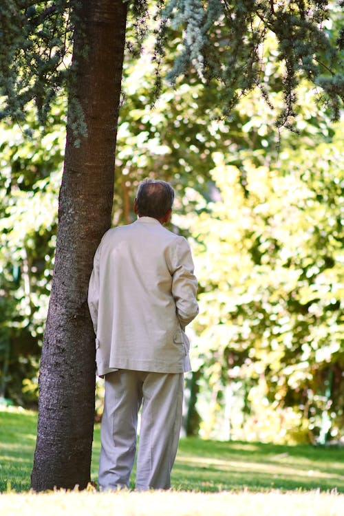 Elderly Man Standing in Suit at Park