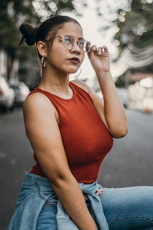Shallow Focus Photo of Woman Holding Her Eyeglasses
