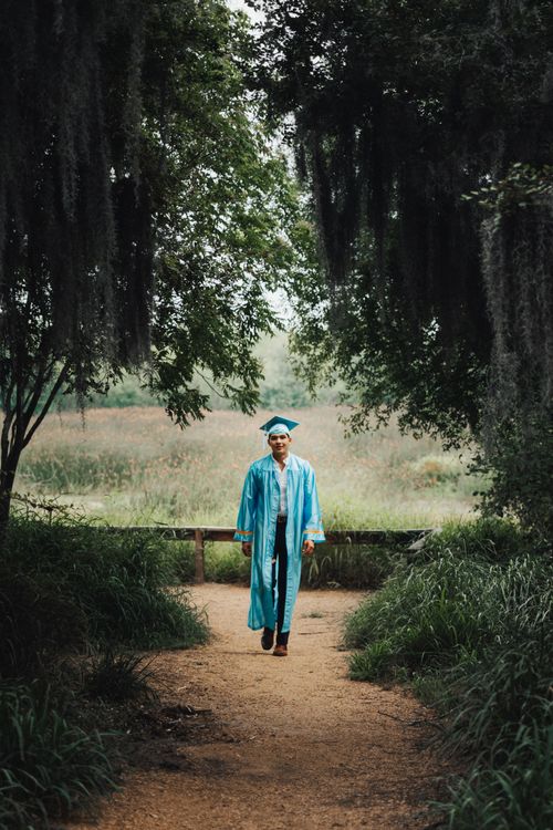 Graduate Walking on Footpath in Forest · Free Stock Photo