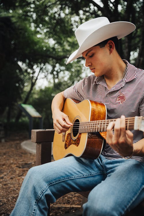 Free Man in Hat Playing Guitar Stock Photo