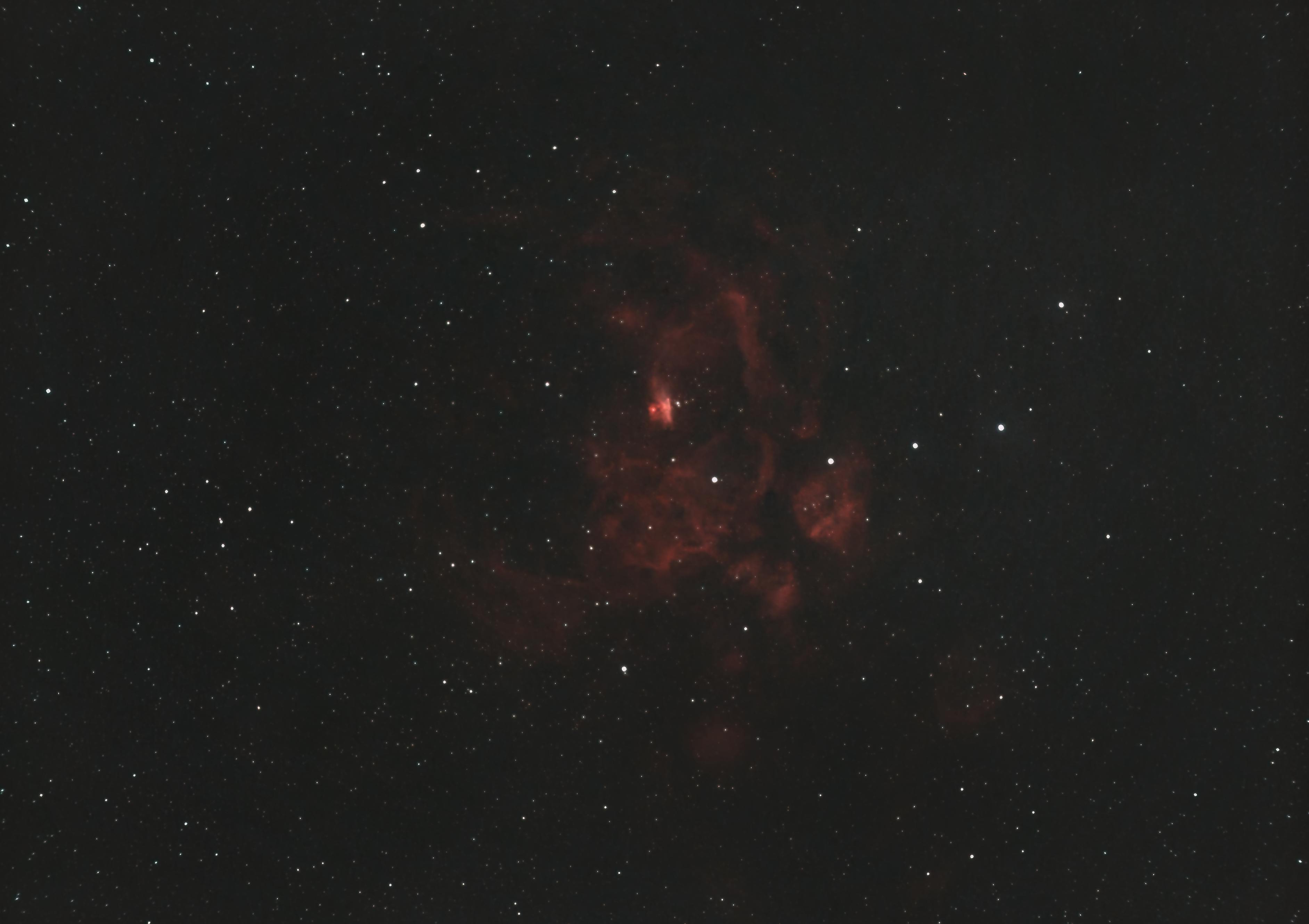 Captivating image of a nebula amidst a field of stars in the night sky.