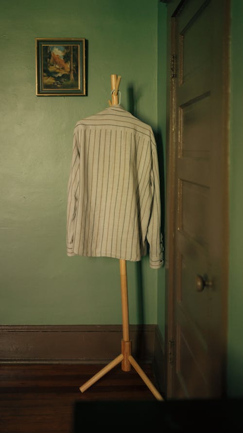 A shirt on a clothes rack in a room