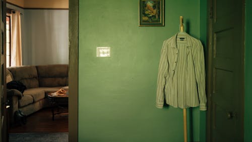 A shirt hangs on a clothes rack in a room