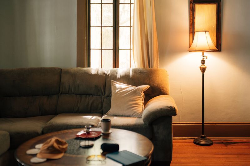 A warm, inviting living room interior featuring a sofa, coffee table, and floor lamp.