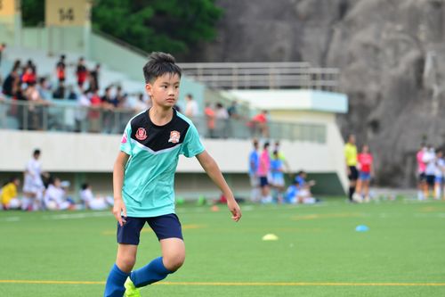 Free A young boy playing soccer outdoors in a sports field, showcasing his focus and determination. Perfect for sports themes. Stock Photo
