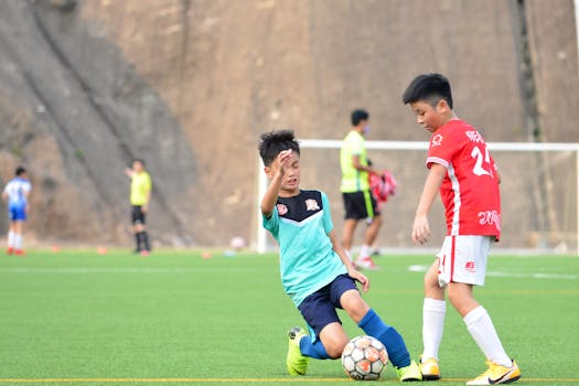 Children enjoying a lively soccer game outdoors, showcasing teamwork and motion on a bright day.