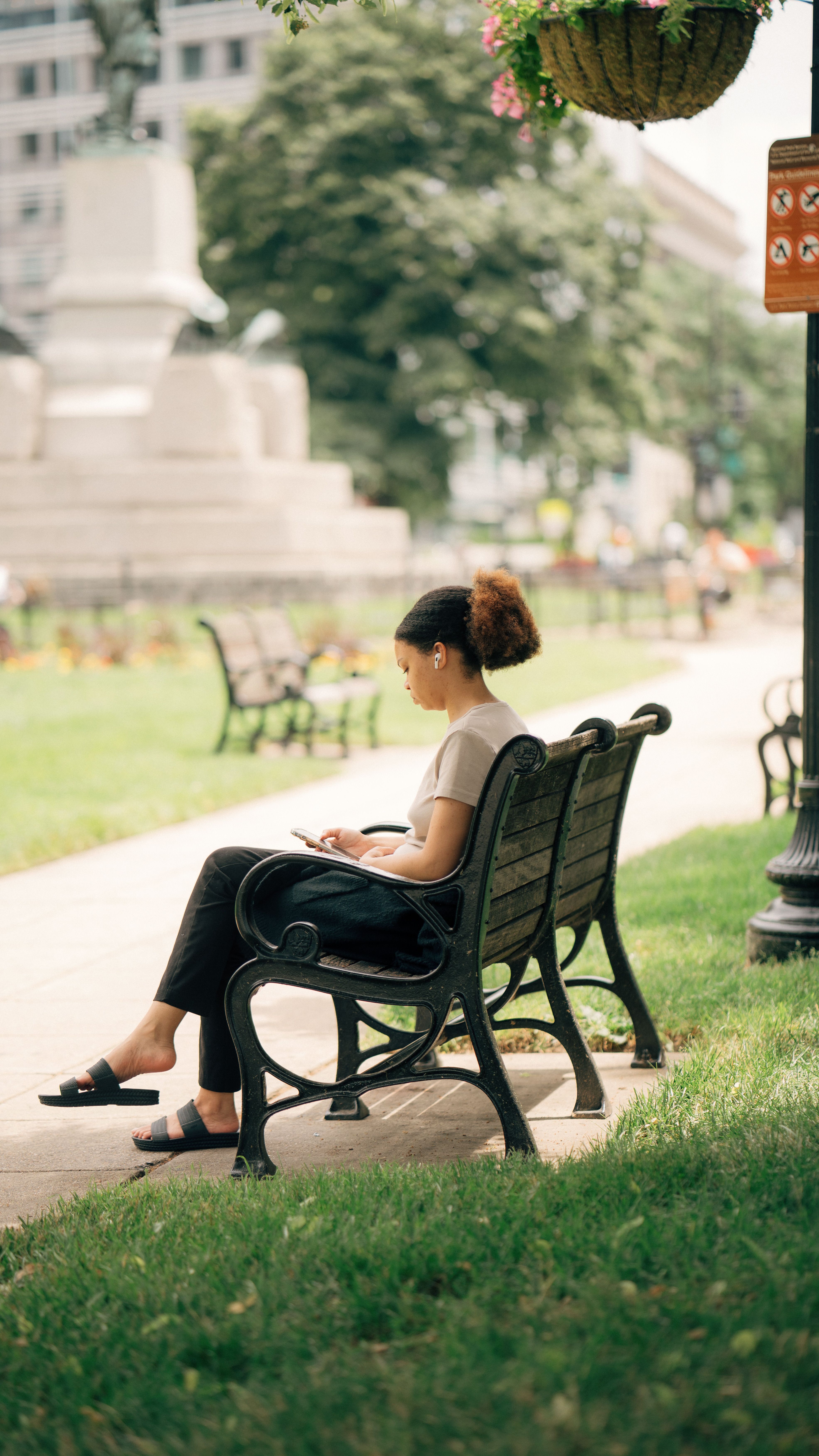 Woman Sitting on a Bench in a Park · Free Stock Photo