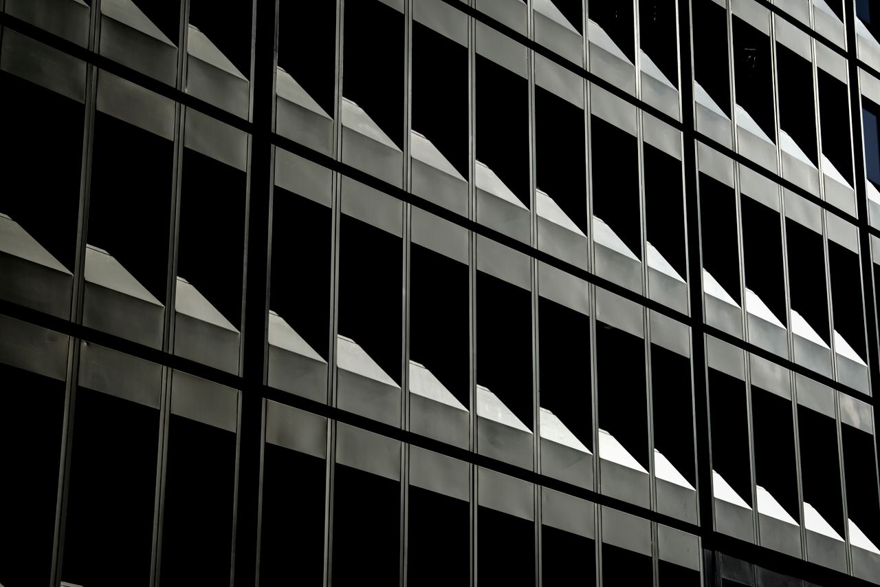 abstract view of an urban office building s repetitive window patterns