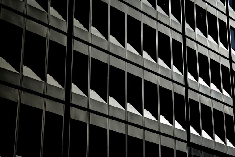 Abstract view of an urban office building's repetitive window patterns — Photo by Sydney Sang on Pexels