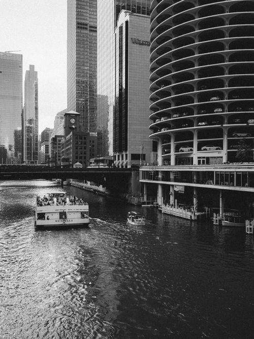 Free Stunning black and white view of Chicago River with iconic skyscrapers and a boat. Stock Photo