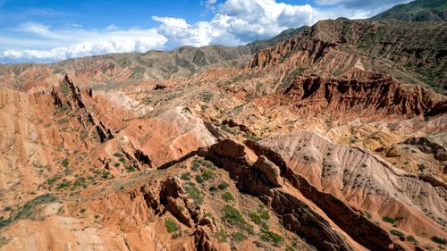 Free Stunning aerial view of vibrant canyons in Manas, Kyrgyzstan under a sunny sky. Stock Photo