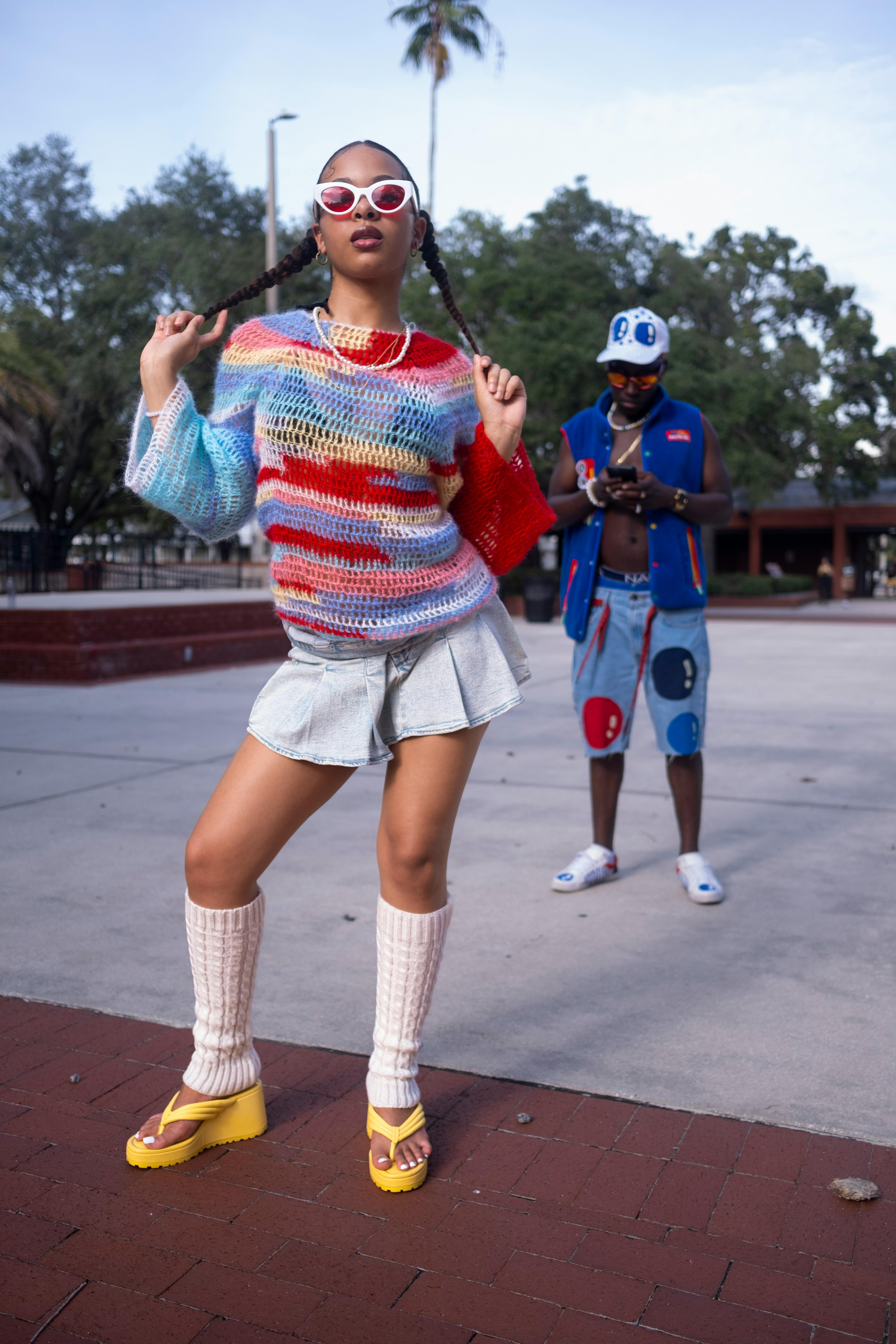 A colorful 2000s inspired street fashion photoshoot featuring two stylish individuals.
