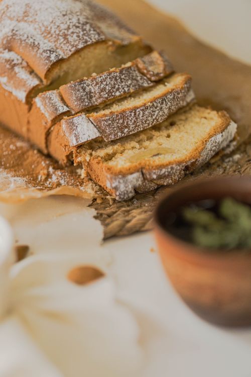 Free Deliciously fresh sliced bread on rustic parchment paper with a cozy background setting. Stock Photo