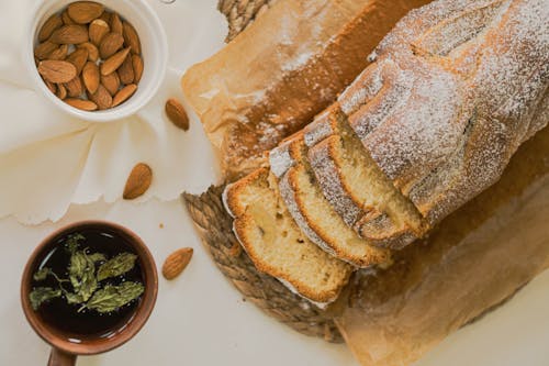 Free A loaf of bread with almonds and a cup of coffee Stock Photo
