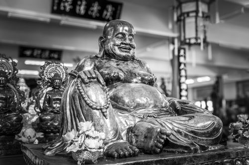 Free Striking black and white photo of a laughing Buddha statue in Pattaya City temple. Stock Photo