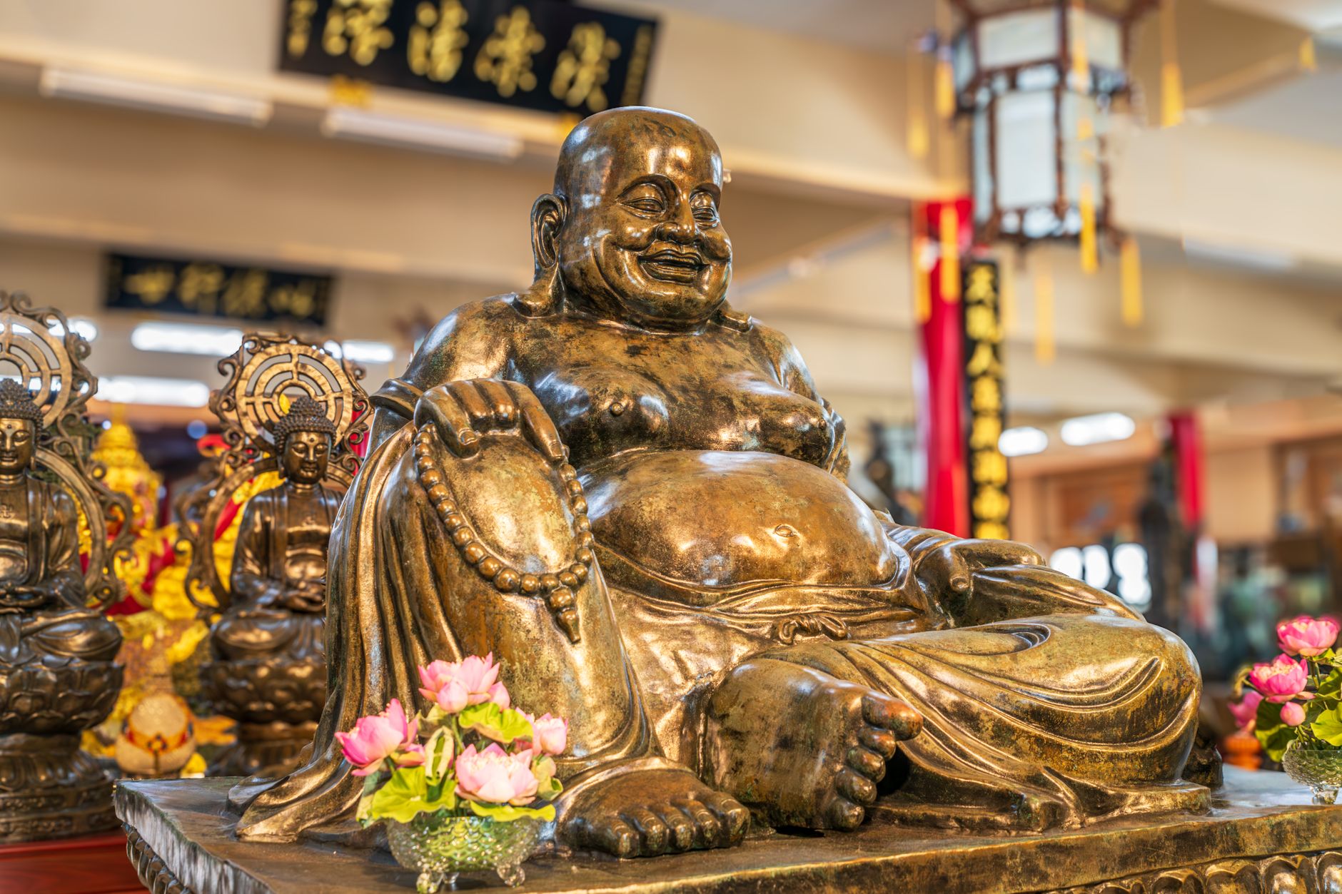 Close-up of a golden Buddha statue in a Pattaya City temple, showcasing intricate details and vibrant decor.