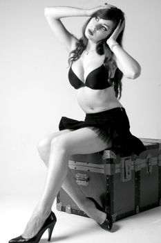 Studio portrait of a woman posing in black lingerie and heels, exuding elegance and style.
