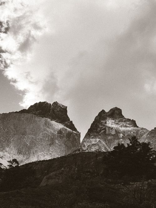 Free Majestic peaks of Torres del Paine under dramatic skies in a black and white capture. Stock Photo