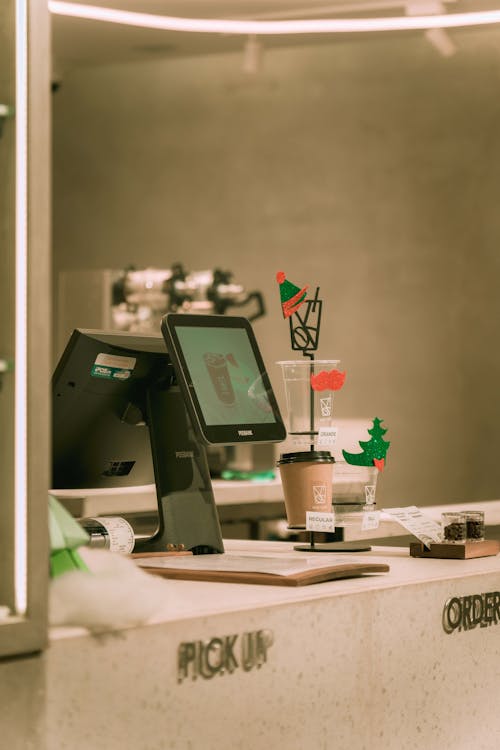 A counter with a computer and a drink · Free Stock Photo
