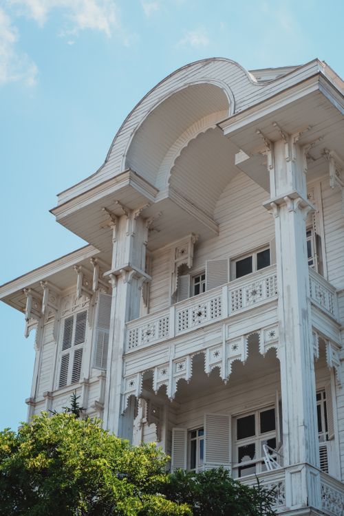 Free Elegant Victorian white building with ornate balconies, captured on a sunny day. Stock Photo