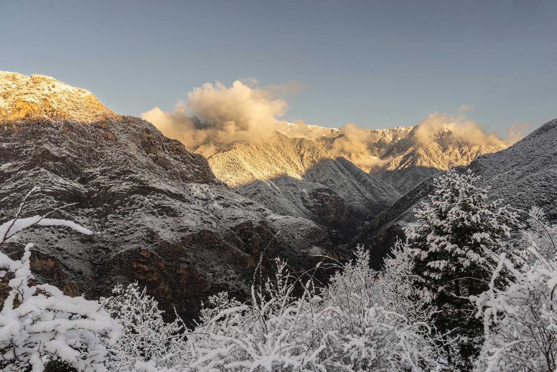 Scenic view of snow-covered Pyrenees mountains in Andorra la Vella, bathed in morning light.
