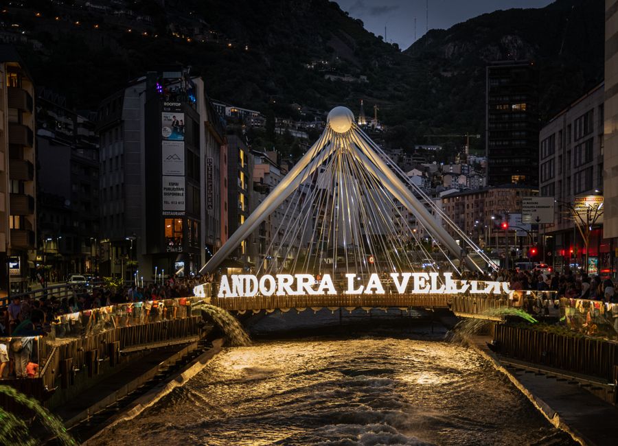 Beautiful evening view of the illuminated Pont de Paris bridge in Andorra la Vella.