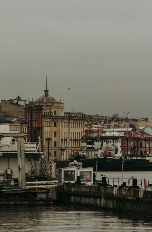 Free Misty view of St. Petersburg's urban waterfront with historic architecture. Stock Photo