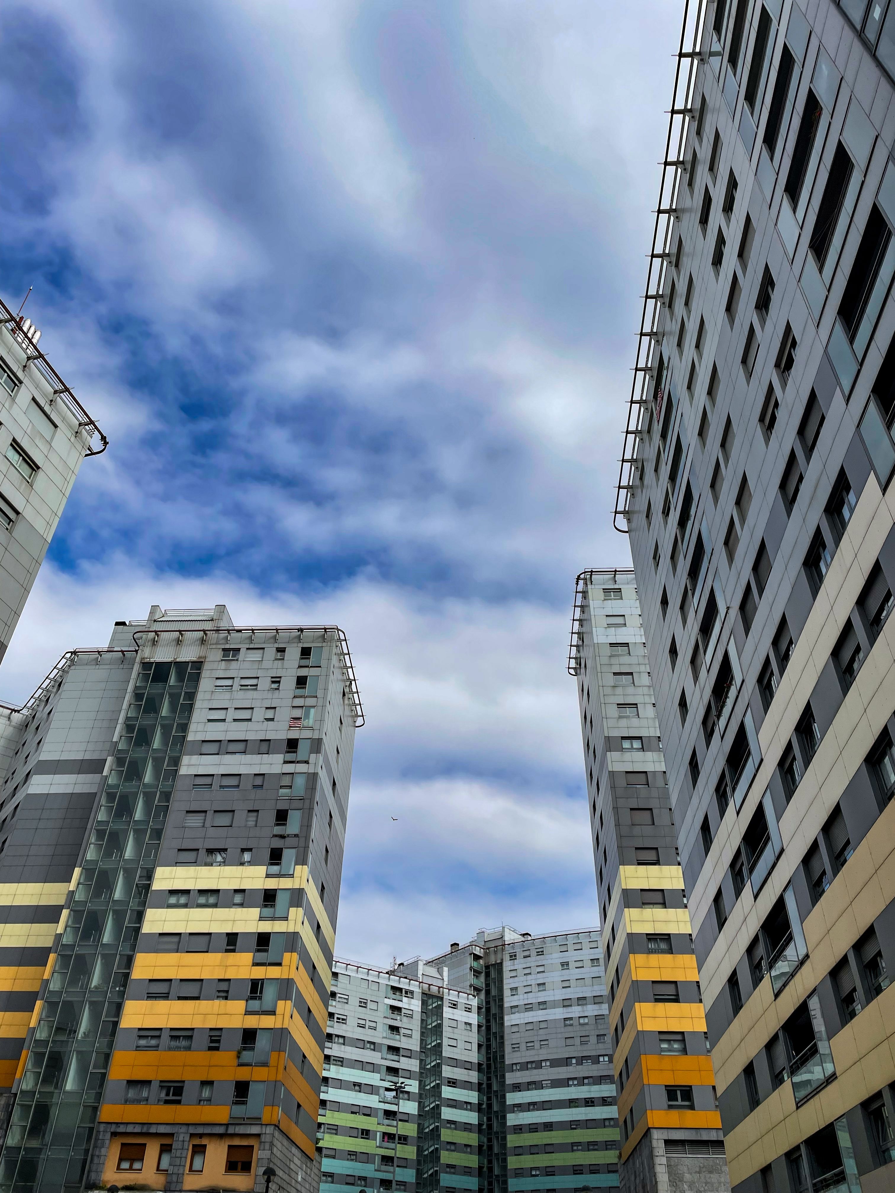 High-rise apartment buildings in Baracaldo, Spain, set against a cloudy sky.