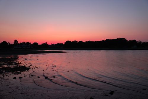 Free Tranquil sunset over a calm lake in Stamford, Connecticut, casting vibrant hues on water ripples. Stock Photo