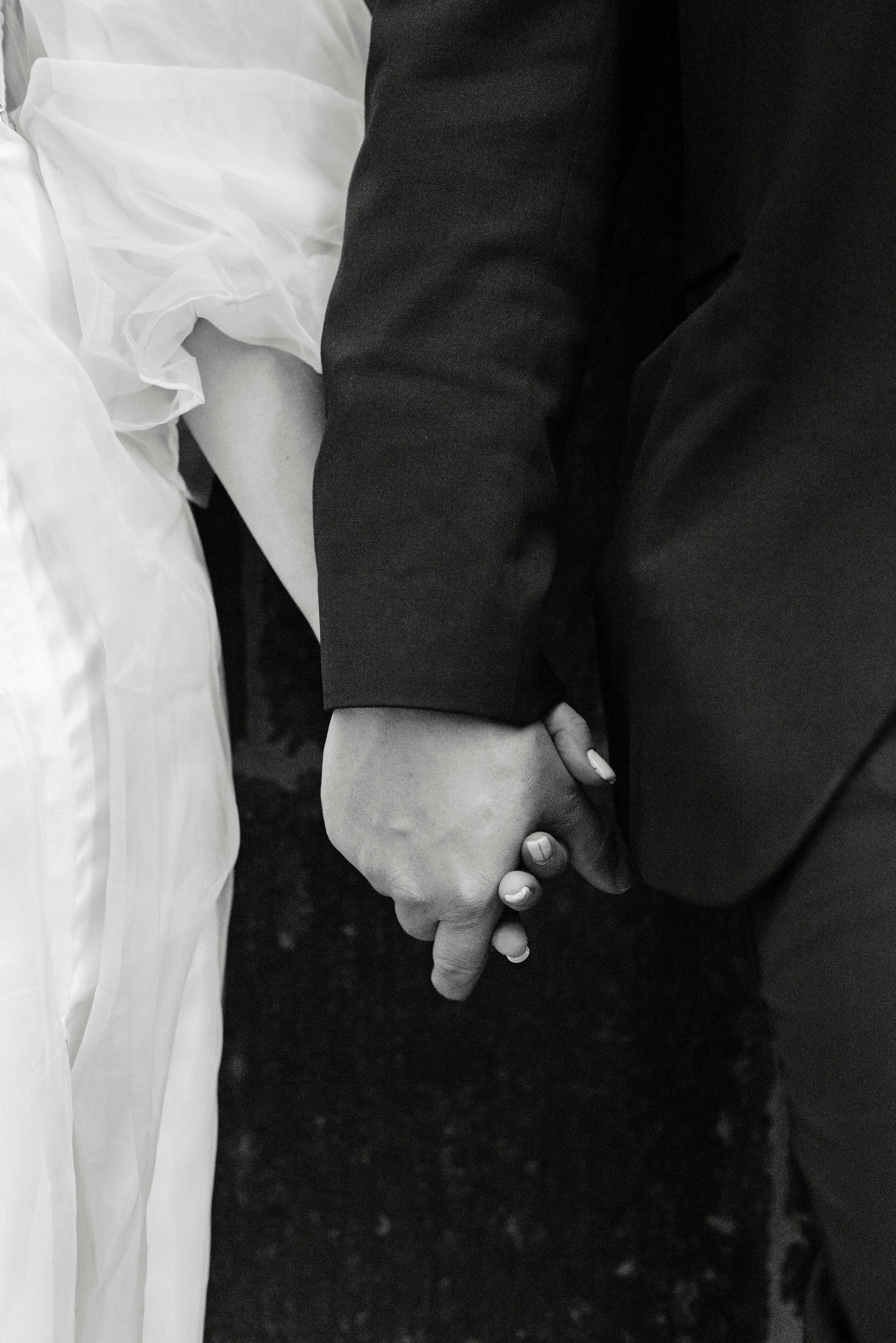 Black and White Photo of a Couple Holding Hands · Free Stock Photo