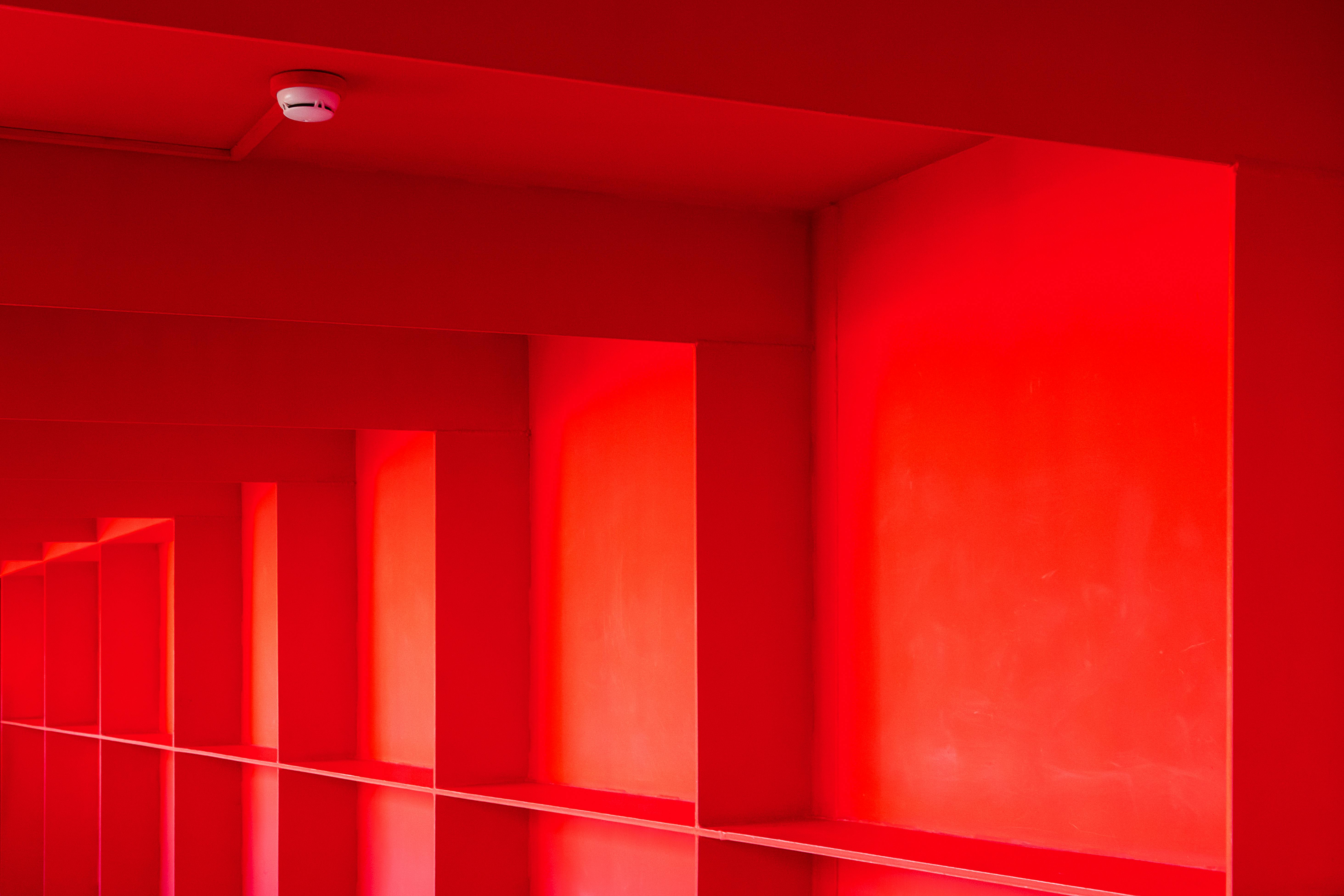 A striking image of a red interior with geometric repetition and symmetry.