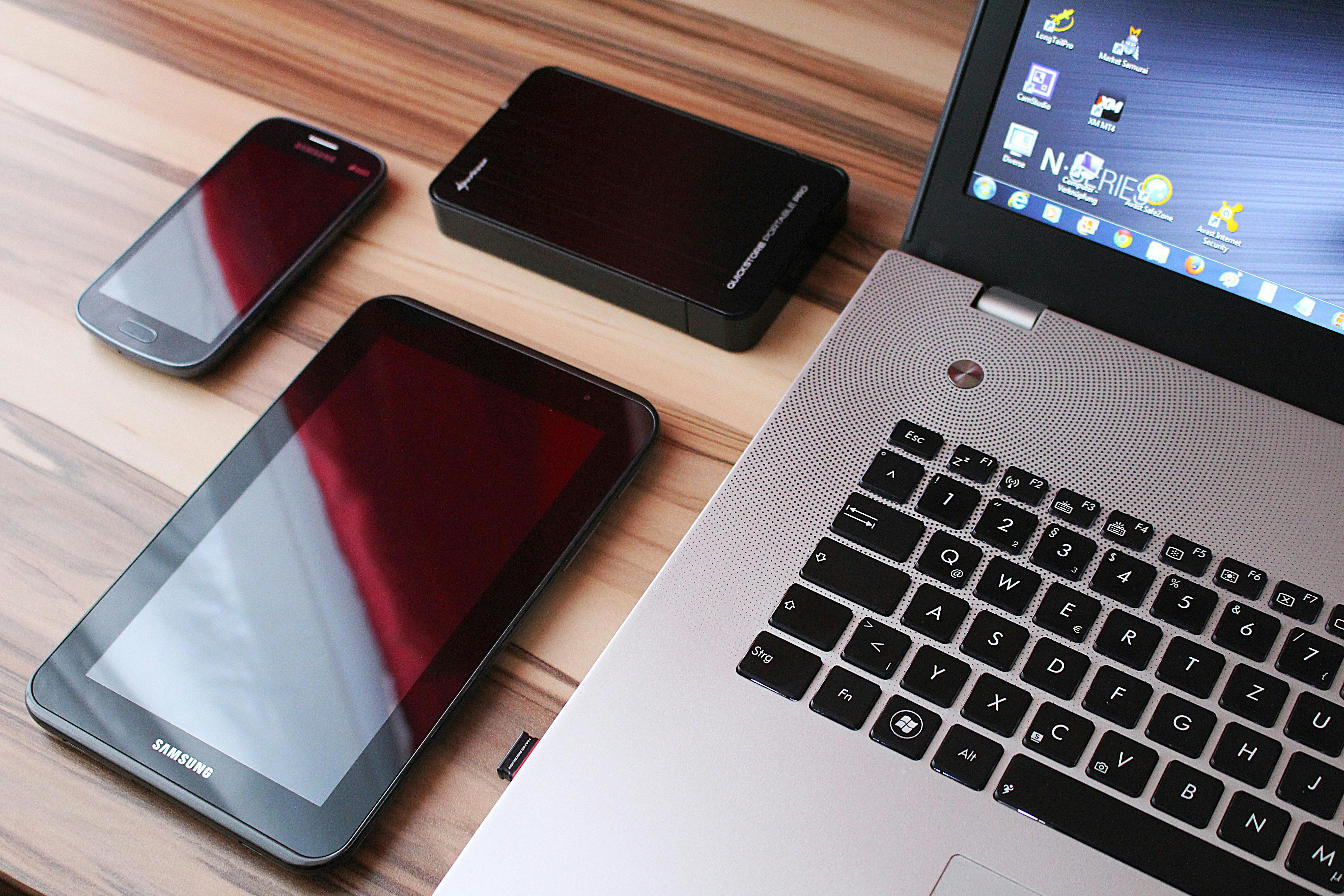 Black Samsung Tablet Beside Laptop Computer