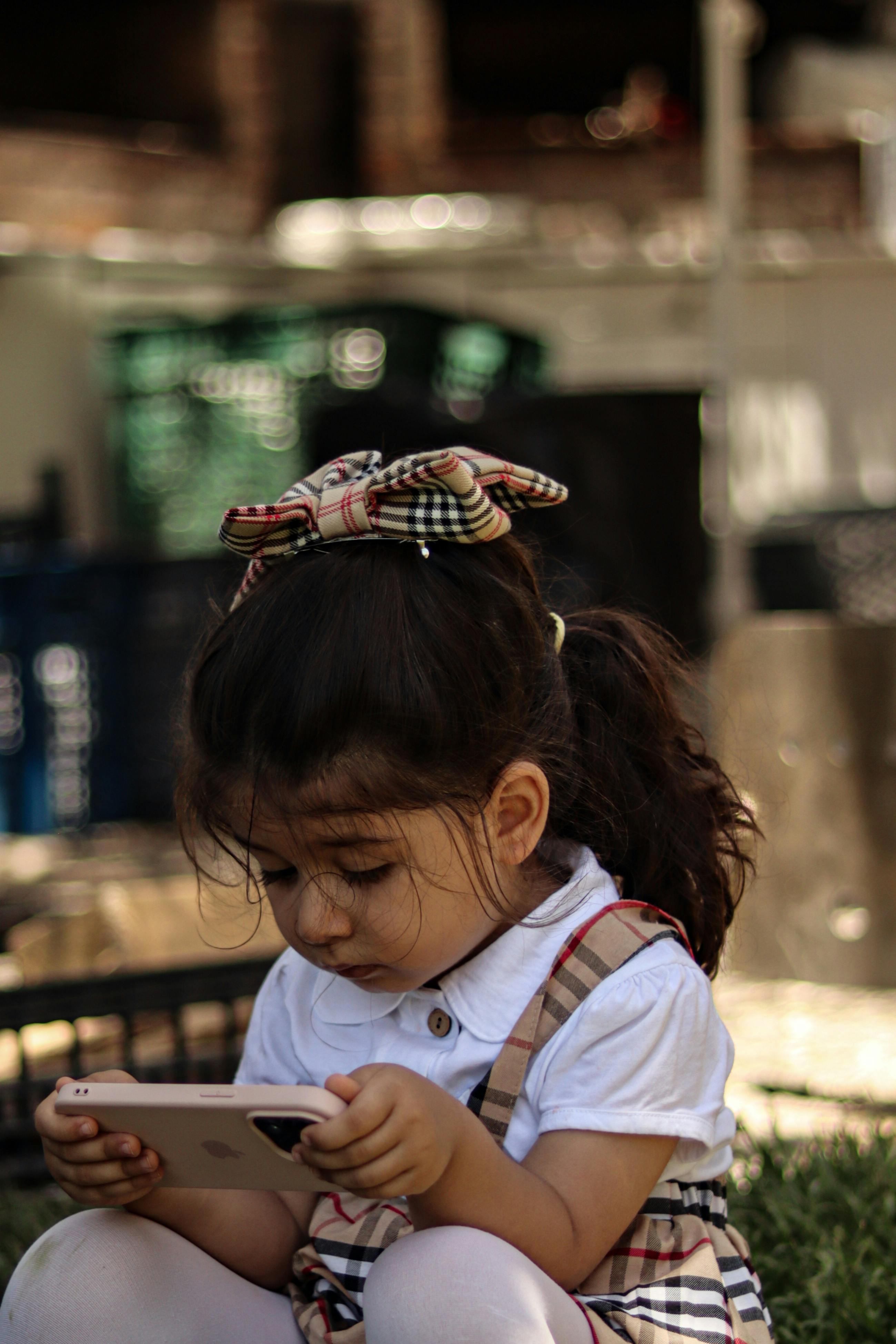 little girl watching mobile phone