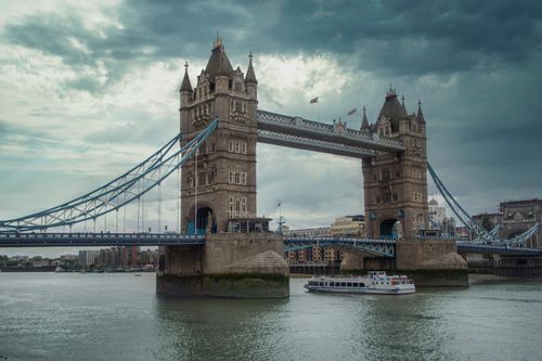 Free Iconic Tower Bridge in London with overcast skies, showcasing the city's architectural landmark. Stock Photo