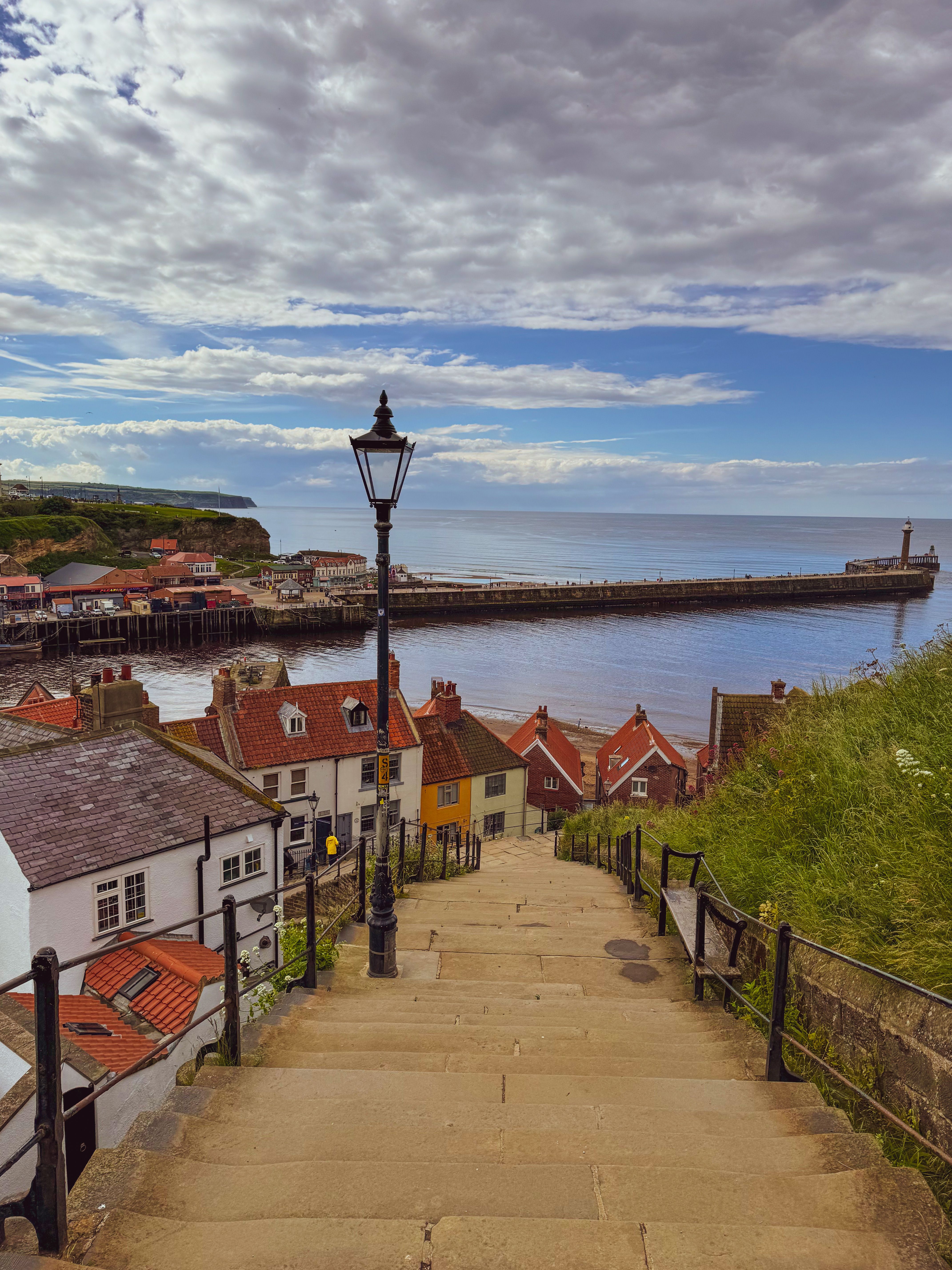 Looking down the 199 Church Stairs towards the harbour piers, red pantile roofs on either side.
