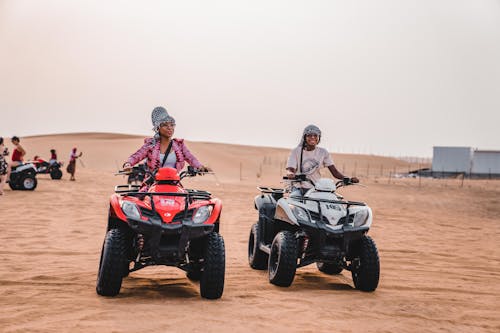 Free Two people riding atvs in the desert Stock Photo