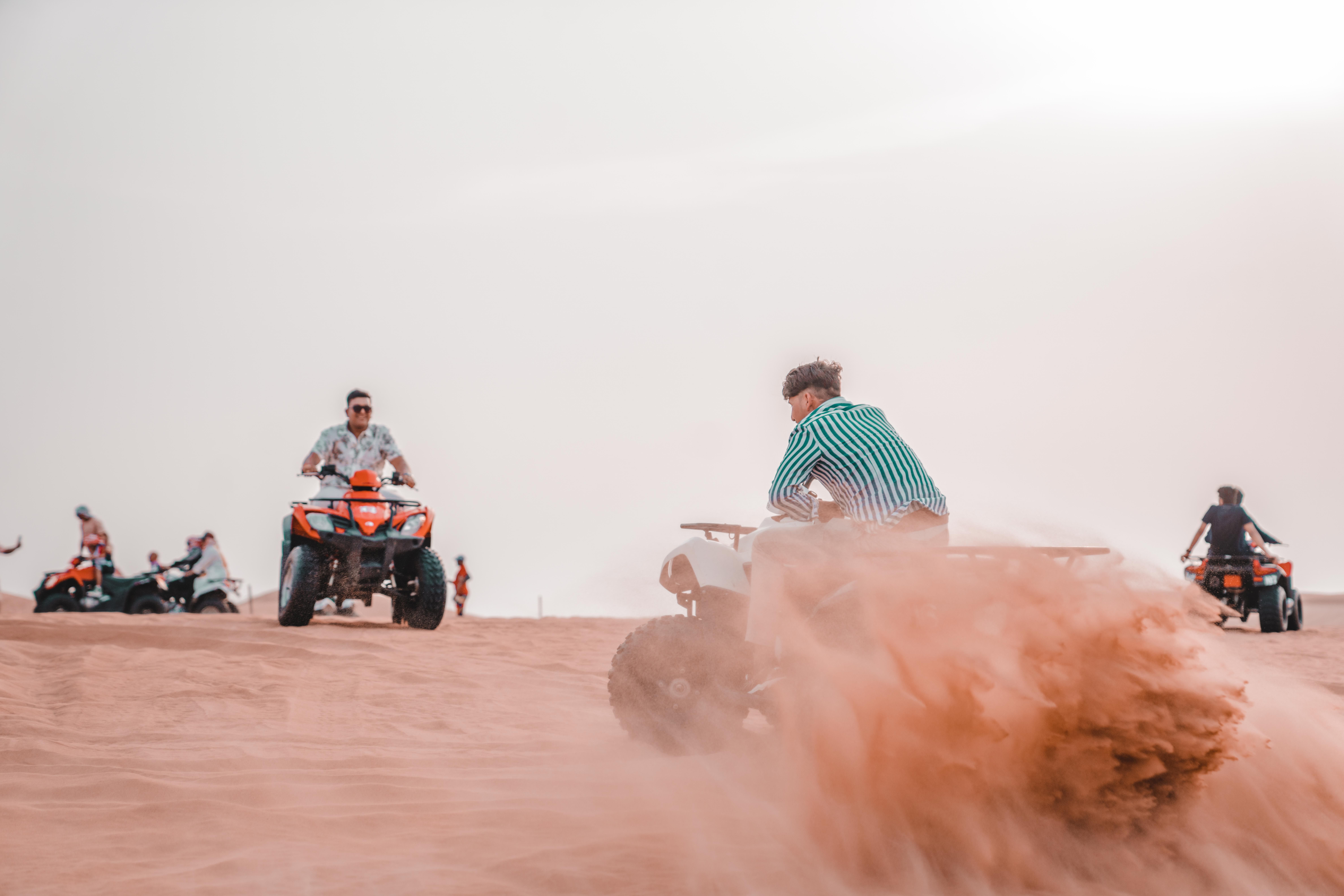 Experience the excitement of quad biking across sandy desert dunes in a thrilling outdoor adventure.