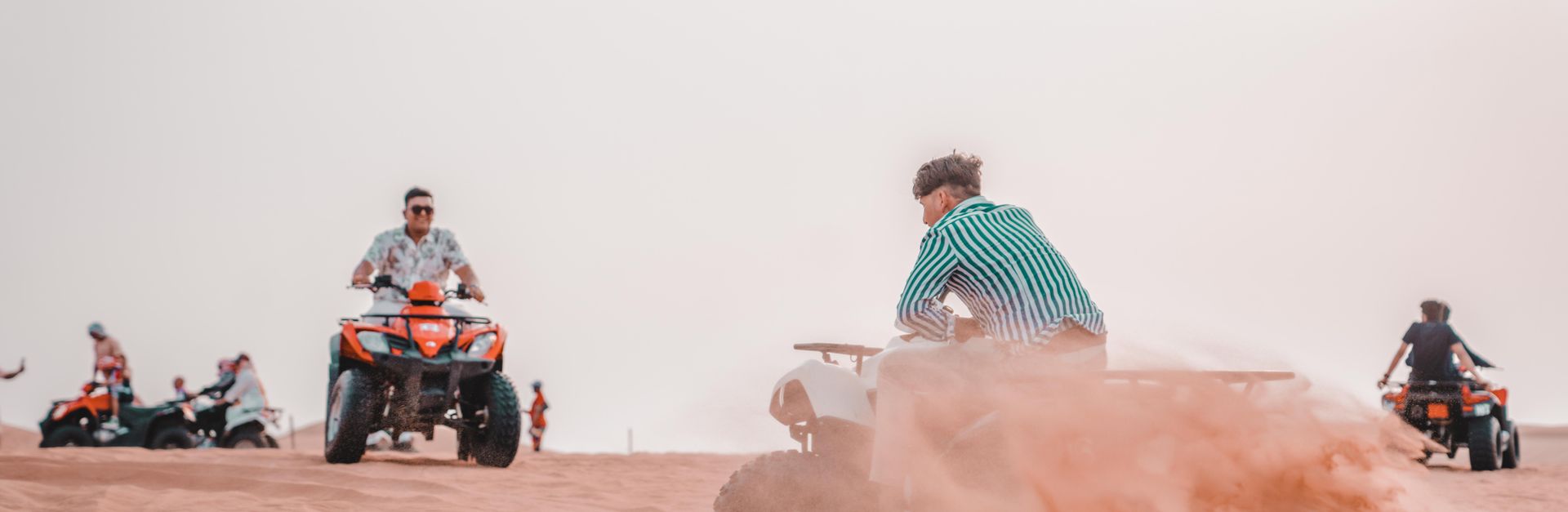 Experience the excitement of quad biking across sandy desert dunes in a thrilling outdoor adventure.