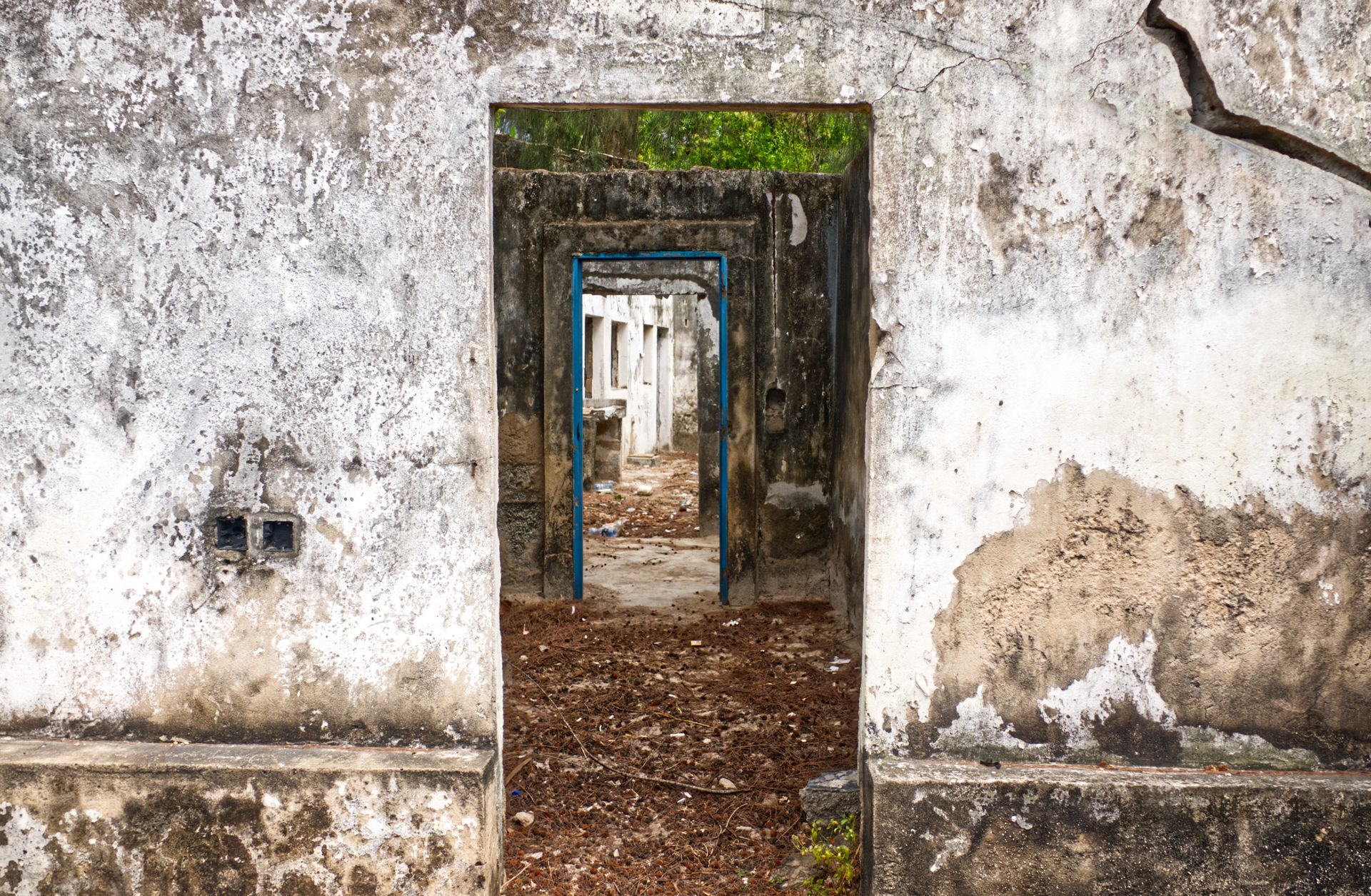 Explore the eerie beauty of an abandoned building's doorways in Mombasa, Kenya.